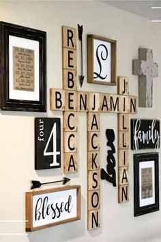 a cross made out of scrabble tiles and framed pictures on the wall with words