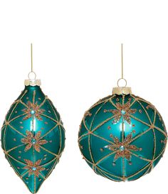 two green christmas ornaments hanging from strings on a white background with gold trimmings