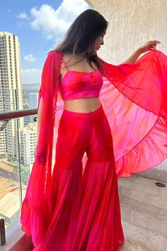 Pink and red long cape with floral print and crystal drop embroidery details. Paired with a sharara and padded printed bustier. - Aza Fashions Cape Sharara, Pink Bustier, Long Cape, Sharara Set, Fashion App, Satin Silk, Crystal Drop, Embroidery Details, Set For Women