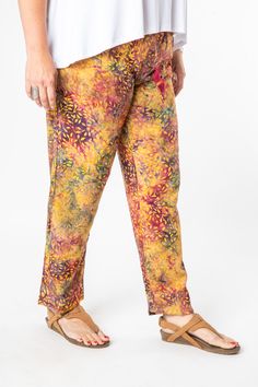 A combination of cool comfort and colorful hippie style are all yours when you slip into these breezy batik straight legged lounge pants. Featuring flowing rayon fabric and an elasticized waist with a drawstring for a cozy and comfortable fit. Each pair of drawstring comfy pants was hand dyed and ethically made by our makers in Bali. The traditional Indonesian batik dye process is an ancient artform and each pair of one of a kind pants helps support this ancient artistic tradition. The perfect p Casual Boho Print Pants For Vacation, Bohemian Rayon Harem Pants For Vacation, Casual Multicolor Harem Pants For Vacation, Casual Boho Print Harem Pants For Vacation, Bohemian Straight Leg Pants For Vacation, Casual Multicolor Harem Pants For Beach, Bohemian Patterned Pants For Vacation, Bohemian Style Patterned Pants For Vacation, Bohemian Straight Leg Harem Pants For Beach