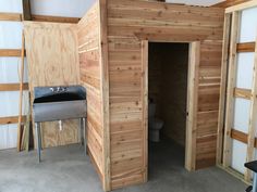 the inside of a building with wood paneling on the walls and floor, as well as a sink