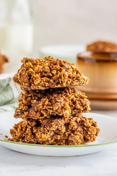 three oatmeal cookies stacked on top of each other in a white plate