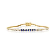 A true classic, our Diamond Four Prong Tennis Bracelet is accented with larger four prong set blue sapphires at the center. Handcrafted in 18-karat yellow gold and set with 1.50 carats of round, brilliant-cut white diamonds this bracelet has timeless appeal - the perfect gift for yourself or someone you love, because diamonds are always a good idea! Bracelet measures 6.5 inches in length Diamond Carat Weight: 1.50 ct Blue Sapphire Carat Weight: 0.53 ct Stone size: 1.5 mm / Accent - 2.5 mm Diamon Classic Yellow Gold Bracelet With Channel Set, Classic Yellow Gold Bracelet Channel Set, Classic Yellow Gold Bracelets Channel Set, Sapphire Tennis Bracelet Fine Jewelry With Prong Setting, Classic Sapphire Tennis Bracelet With Prong Setting, Classic Yellow Gold Diamond Bracelet With Channel Set, Classic Sapphire Tennis Bracelet With Brilliant Cut, Classic Yellow Gold Diamond Bracelet Channel Set, Classic Yellow Gold Channel Set Diamond Bracelet