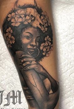 a woman with flowers on her head is shown in this black and grey tattoo design