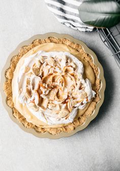 a pie sitting on top of a table next to a plant