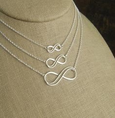 Sterling silver double infinity necklace, infinity knot, infinity symbol, bridal jewelry, sterling silver necklace, eternity necklace A double wire infinity link is attached to a sterling silver chain that can be any length up to 22 inches in length and is secured with a sterling silver lobster claw clasp. You can choose between the small, medium, and large infinity links. The small infinity measures 0.55 x 0.26 inches (14 x 6.5mm). The medium infinity measures 0.79 x 0.37 inches (20 x 9.5mm). T Elegant Sterling Silver Infinity Necklace, Silver Infinity Necklace In Dainty Style, Silver Infinity Dainty Necklace, Sterling Silver Infinity Necklace With Adjustable Chain, Silver Infinity Jewelry With Adjustable Chain, Silver Infinity Necklace With Delicate Chain, Silver Dainty Infinity Necklace, Silver Infinity Jewelry, Dainty Silver Infinity Necklace