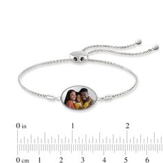 Create a Personalized and sure-to-be-treasured everyday accessory with this engravable photo oval bolo bracelet in silver. Fashioned in sterling silver The dainty oval-shaped disc features your photo - expertly transferred using modern technology and is scratch resistant and 100% waterproof. Further customize the design with a sweet message - up to 15 characters in length - inscribed along the backside. This wheat chain bracelet adjusts up to 7.0 inches in length and secures with a bolo clasp and ball ends. Please follow these steps: 1) Place your order; 2) Text your photo from your smartphone to (972) 483-2900; and 3) When prompted, please respond with your Order Confirmation #. Standard text messaging rates may apply. White Gold Oval Bracelets For Everyday, Engraved Adjustable Oval Bracelets, Personalized Oval Pendant Jewelry, Adjustable Oval Engraved Bracelets, Adjustable Oval Bracelets, Adjustable Oval Bracelets For Everyday, Engraved Oval Bracelets, Oval Engraved Bracelets For Gifts, Engraved Oval Sterling Silver Bracelets