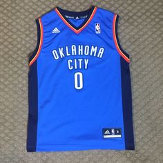 This Russel Westbrook Jersey Is In Perfect Condition! The Logos And Letters Are Not Faded, And Look Brand New. There Are No Rips, Stains, Or Tears. Super Comfy, And Would Be Perfect For An Okc Fan, Or Jersey Collector! Adidas Blue Sleeveless Top, Russel Westbrook, Adidas Blue, Blue Adidas, Be Perfect, Blue Orange, Kids Shirts, Shirts Tops, Kids Shop