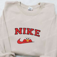 The Nike x Elmo Cartoon Embroidered Sweatshirt is a must-have for any fan of the iconic Sesame Street character. Made from premium quality materials, this sweatshirt features a vibrant and detailed embroidery of Elmo, adding a playful touch to your outfit. With its comfortable fit and cozy fabric, it is perfect for chilly days or [...] Nike Cartoon, Nike Inspired, Best Family Gifts, Cap Men, Sports Hoodies, Hoodie Material, Movie Shirts, Custom Nikes, Nike Sweatshirts