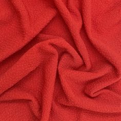 the red fabric is very soft and has been folded up to show it's texture