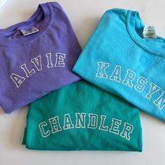 Best selling comfort colors tees paired with your little one's name in a cute curved varsity font. Made from 100% cotton, garment dyed, and super cozy! Your little one will make a statement in this tee! If you are wanting a different design, more wording, or a different clothing style, please send me a message so we can discuss the details. Casual Tops With Embroidered Text For School, Cotton Tops With Custom Embroidery For School Spirit, School Spirit Cotton Top With Custom Embroidery, School Spirit Tops With Custom Embroidery And Short Sleeves, Cotton T-shirt With Letter Embroidery For College, Casual School Tops With Letter Embroidery, Casual Tops With Letter Embroidery For School, Casual Letter Embroidery Tops For School, College Green Top With Embroidered Text