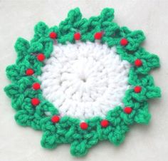 a crocheted christmas ornament on a white surface