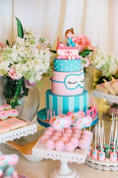 a table topped with lots of cakes and desserts