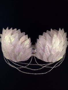 the headpiece is adorned with pearls and feathers