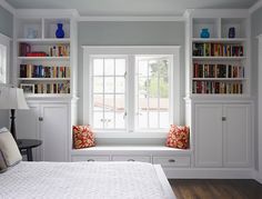 a bedroom with built in bookshelves and a bed