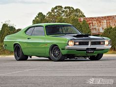 a green muscle car parked in a parking lot