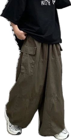 Baggy Khaki Wide-leg Parachute Pants, Baggy Khaki Parachute Pants With Pockets, Baggy Khaki Wide Leg Pants With Elastic Waistband, Baggy High Waist Khaki Harem Pants, Baggy Khaki Harem Pants For Streetwear, Casual Oversized Harem Pants With Pockets, High Waist Baggy Khaki Harem Pants, Khaki Wide Leg Harem Pants For Streetwear, Khaki Wide-leg Harem Pants For Streetwear