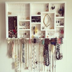 a white wall filled with lots of jewelry