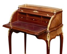 an antique wooden desk with gold trimmings