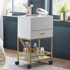 a white and gold cart with various items on it