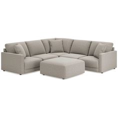 a large sectional couch and ottoman with pillows on the bottom, in front of a white background