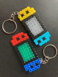 two lego keychains made to look like they are being played in a video game