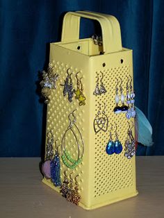 a yellow bag with earrings on it sitting on a table