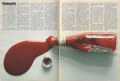 an open magazine with a red bottle on it