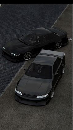 two black cars parked next to each other