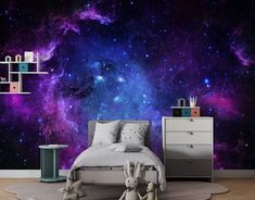 an image of a bedroom setting with space wallpaper and stars in the sky behind it