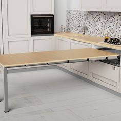 a kitchen with white cabinets and an island table in front of the stove top oven