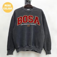 Perfect sweatshirt for Nick Bosa and San Francisco football fans this season! Ideal for any situation, a unisex heavy blend crewneck sweatshirt is pure comfort. These garments are made from polyester and cotton. This combination helps designs come out looking fresh and beautiful. The collar is ribbed knit, so it retains its shape even after washing. There are no itchy side seams on these sweaters.  .: 50% cotton, 50% polyester .: Medium-heavy fabric (8.0 oz/yd² (271.25 g/m .: Loose fit .: Sewn-i Collegiate Crew Sweatshirt With Screen Print, Collegiate Style Crew Sweatshirt With Screen Print, Winter Fan Merchandise Sweatshirt With Letter Print, Collegiate Crew Sweatshirt With Letter Print, Fan Gear Graphic Print Hoodie With Crew Neck, Team Spirit Streetwear Hoodie With Crew Neck, Varsity Crew Sweatshirt With Screen Print, Sports Season Crew Neck Sweatshirt With Screen Print, Pre-shrunk Crew Neck Hoodie For Fan Gear