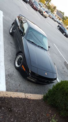 a black sports car parked in a parking lot