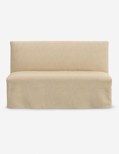 the back of a beige couch on a white background with no one sitting in it