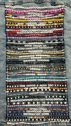 the back pocket of a jean jacket with beads and buttons in different colors on it