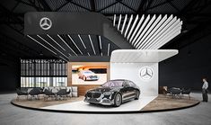 a mercedes showroom with a car on display