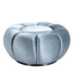 a round blue ottoman with pleated fabric on the bottom and metal base, sitting in front of a white background