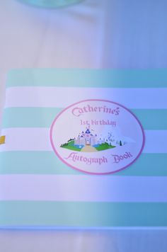 a blue and white striped table cloth with a castle sticker on the front of it