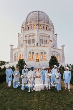 a group of people standing in front of a large building with a dome on top