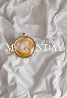 there is a cup of coffee on top of a white sheet with the words hello monday