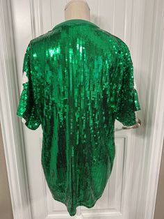 SIZE: One Size Fits Most (comfortably fits up to 1XL)Length (top to bottom) - 31 inchesBust - 23 inches across Sleeve width - 10 inches widede Green Sequin Tops For Fall, Green Stretch Sequined Tops, Green Sequined Stretch Tops, Green Sequined Tops For Spring, Green Sequined Short Sleeve Tops, Fitted Green Top For Party Season, Fitted Green Tops For Party Season, Green Long Sleeve Sequin Top, Green Sequined Long Sleeve Top