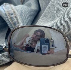 a woman taking a selfie in the reflection of a mirror with her cell phone