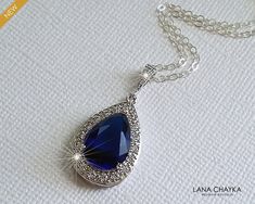 Wedding Sapphire Royal Blue Navy Blue Cubic Zirconia Teardrop Halo Pendant with .925 Sterling Silver Chain Bridal Necklace. Glamorous and elegant, this necklace is perfect for weddings or special occasions such as birthdays, anniversaries, graduations, proms...or whatever you can imagine! CHAIN is 18 inches (45.7 cm) long. PENDANT is about 1.18 inch (3cm) long including bail. Handmade necklace, is made with .925 Sterling Silver 18 inches long cable chain, Rhodium Plated pear shaped Sapphire Navy Blue Teardrop Jewelry For Wedding, Blue Drop Jewelry For Wedding, Blue Teardrop Wedding Jewelry, Sapphire Drop Necklace For Wedding, Blue Teardrop Pendant Jewelry For Formal Occasions, Blue Teardrop Necklace For Wedding, Blue Teardrop Pendant For Formal Occasions, Blue Pear-shaped Necklace For Formal Occasions, Blue Pear-shaped Jewelry For Party