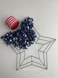 a red, white and blue pinwheel sitting on top of a star shaped object