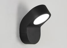 a black wall light mounted on the side of a white wall