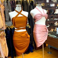 two dresses on mannequins in a clothing store