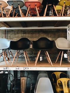 many chairs are stacked on top of each other in a storage area at the furniture store