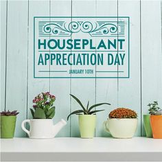 there is a sign that says houseplant appreciation day on the wall above some potted plants