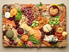 a platter filled with lots of different types of fruit and veggies on top of each other