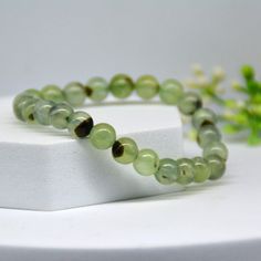 Bead Diameter：Approximately 0.3in Total Weight: Approximately 17.3g  This natural prehnite bead bracelet showcases a distinctive green color, with each bead delicately infused with black elements. Handcrafted, exquisite, and of high quality, it is suitable for daily wear and adds a touch of sophistication to special occasions. Unique and meaningful, it makes the perfect gift for someone special.Comes with an exquisite box. Cheap Hypoallergenic Green Bracelets, Cheap Green Hypoallergenic Bracelets, Crystal Bracelet, Crystal Bracelets, Arm Band, Good Luck, Green Colors, Light Green, Jewelry Bracelets